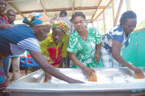 Some of the participants demonstrating how gari is produced, at the event