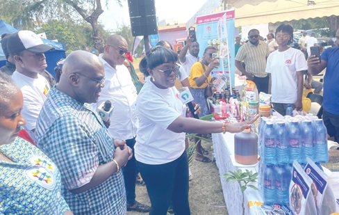 Julius Debrah (2nd from left), Chief of Staff, inspecting some of the products exhibited at the event