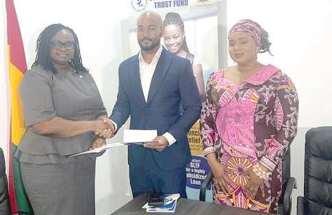 Cynthia Amerley Amartefio (left), Board Chairperson of the SLTF, exchanging the MoU with Kelvin Boateng, CEO of Access Plus . Looking on is Dr Saajida Shiraz, CEO of SLTF