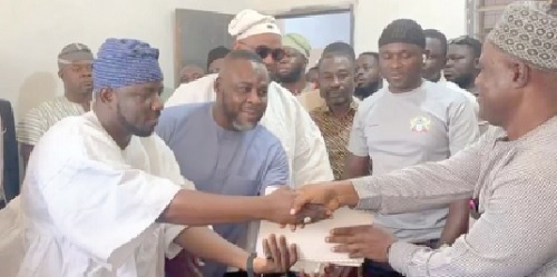 Prof. Seidu Mahama Alidu (left) presenting the nomination forms to Anaba Samson (right), Tamale Metro EC Director