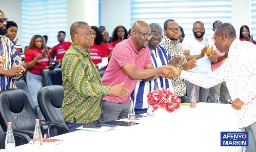 Alexander Kwamena Afenyo-Markin (right), Minority Leader and Member of Parliament for Effutu in a handshake with Hamza Suhuyini, Member, NDC Communications Team at the UniMAC Political StrategyLab Programme.  With them are Mussa Dankwah, Executive Director, Global InfoAnalytics and other dignitaries.