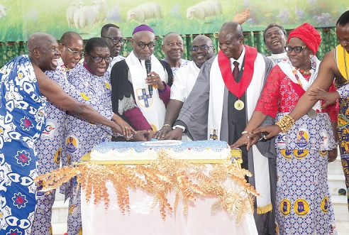 Prof. Kwabena Asamoah-Gyadu (middle), Presiding Bishop of the Methodist Church-Ghana, being assisted by Julius Debrah (3rd from right), Chief of Staff; Most Rev. Dr Paul Kwabena Boafo (3rd from left), and other dignitaries to cut the anniversary cake. Picture: CALEB VANDERPUYE
