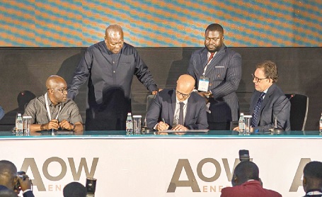 President Mahama (2nd from left) witnessing the signing of the agreement
