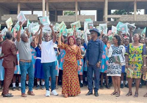 Faustina Akurugu Elikplim (middle), MP for Dome-Kwabenya, Eric Sey (3rd from right), Municipal Director of Education, GA East, and some students and teachers after the donation 