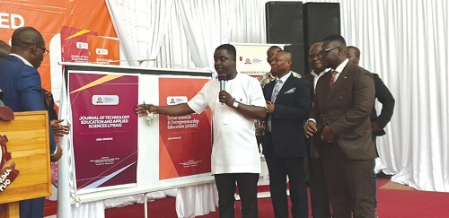 Professor Eric Appau Asante, Director, E-Learning Centre, KNUST, launching the two journals while other officials look on.