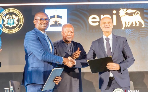 John Abdulai Jinapor (left), Minister of Energy and Green Transition, exchanging documents with Mario Bello (right), the Eni  Executive Vice-President, Sub-Sahara Africa Region, after the signing ceremony. With them is President John Dramani Mahama