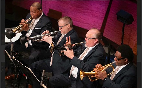 Wynton Marsalis (left) and a section of the JLCO Jazz at Lincoln Center Orchestra with Marsalis follow giant steps to Ghana