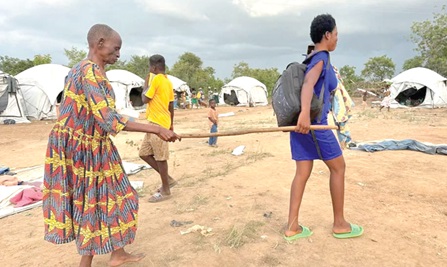 A blind woman being assisted by her granddaughter to return home