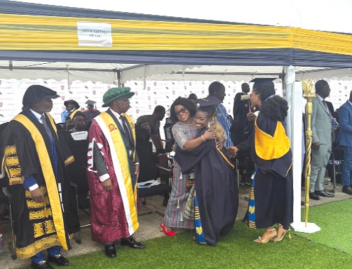 Prof Smile Dzisi, Deputy Director-General of GES in-charge of Management Services, embracing one of the graduates