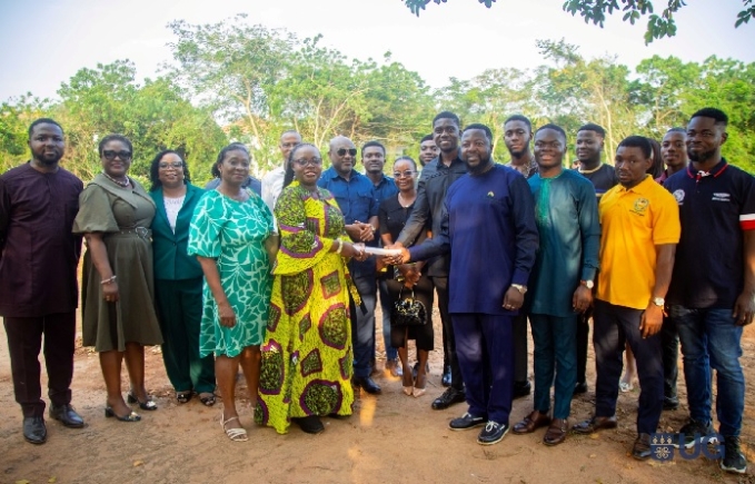 Vice-Chancellor Professor Nana Aba Appiah Amfo presenting land documents to the student leaders 