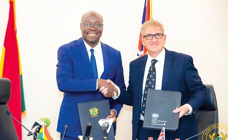 Dr Cassiel Ato Forson (left), Minister of Finance, exchanging the signed agreement with John Humphrey, His Majesty's Trade Commissioner for Africa