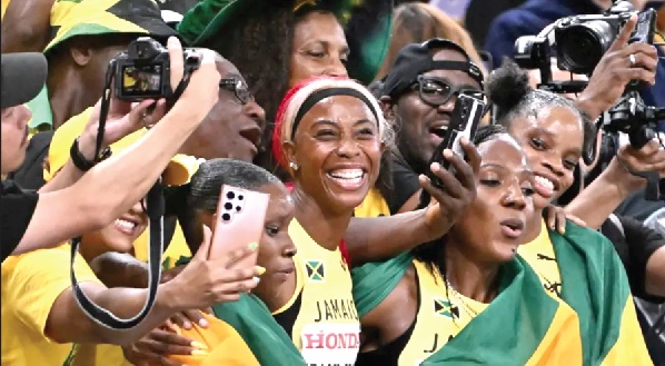 Shelly-Ann Fraser-Pryce (middle) and her relay team celebrate their win Shelly-Ann Fraser-Pryce (middle) and her relay team celebrate their win