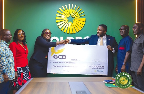 Richard Nunekpeku (right), Deputy Chief Executive Officer of the GoldBod, presenting the cheque to Obuobia Darko Opoku, Administrator of the MahamaCares Fund