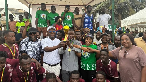 Sports Minister Kofi Iddie Adams hands trophy to Alfred Nii Kotey Ashie, Odododiodio MP and captain of Team James Town Sports Minister Kofi Iddie Adams hands trophy to Alfred Nii Kotey Ashie, Odododiodio MP and captain of Team James Town