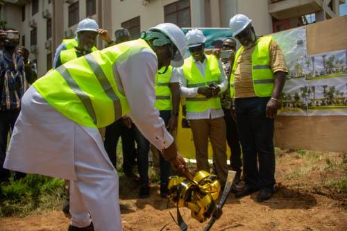 Prof Muhammed Muniru Iddrisu,  Principal of the UDS Nyankpala Campus breaking the ground for the project, looking on are officials of UDS and MTN Ghana Foundation