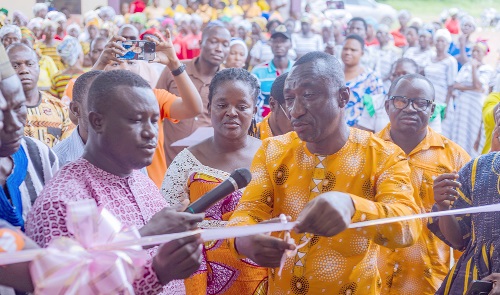 Issahaku Ibrahim, Bolga Branch Sales and Services Manager, being assisted to cut the tape to inaugurate the school.