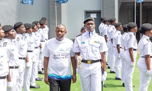 Richard Fedieley, Director-General, Administration, Ministry of Transport, inspecting a guard of honour mounted by cadets of  the Regional Maritime University at the event