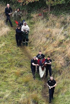 Officers were photographed leading the "tribe" from their camp Officers were photographed leading the "tribe" from their camp