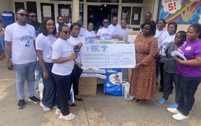 Members of the North Ridge Lyceum Class of 2000, led by Ms Anna Betsylee Agyepong, presenting a dummy cheque and medical supplies to staff of the Child Health Department of the Korle Bu Teaching Hospital .