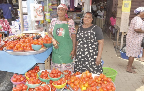 Vic Atsu (right) and Christine Appiah, tomato sellers in the Ho Central Market, desperately awaiting clients