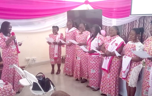 Akua Bonsu-Owu (left), National President, AWAG, swearing in the executive of the Ashanti Region chapter of AWAG during the ceremony
