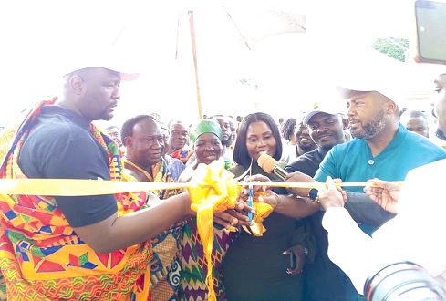 Julius Neequaye Kotey (left), Chief Executive Officer of DVLA, being assisted by Dorcas Affo-Toffey (3rd from right), Deputy Minister of Transport, and George Spencer Quaye (right), Board Chairman of DVLA, to inaugurate the Bechem office. INSET: The Dormaa-Ahenkro DVLA office complex