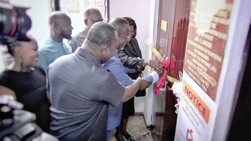 Justice Paul Baffoe-Bonney, the acting Chief  Justice, being assisted by the President of the GhIE to cut the tape to officially open the ADR Centre