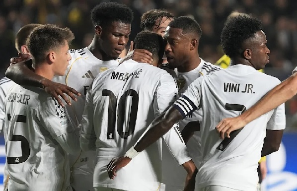 Kylian Mbappé (mobbed by teammates) rewards Madrid's long journey with hat trick in 5-0 win at Kairat Almaty in Champions League