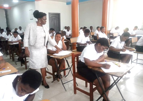 Dr Rosemond Wilson (left), Head, National Office, WAEC, observing a candidate writing the 2025 WASSCE at Accra High School