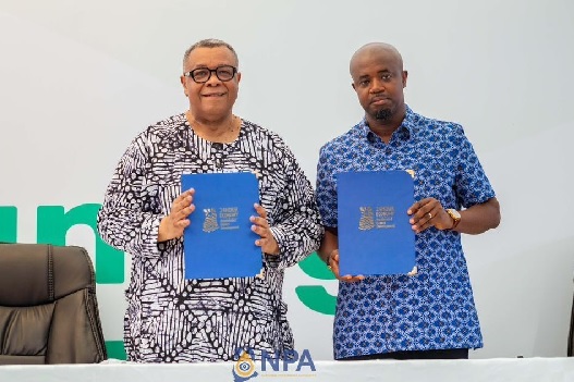 Godwin Edudzi Tameklo (right), CEO of NPA and  Augustus Goosie Tanoh, Presidential Adviser on the 24-Hour Economy and Accelerated Export Development displaying the signed documents 