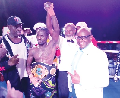 Referee Roger Barnor declares Michael Ansah the winner, as he proudly shows off his Azumah Nelson title belt
