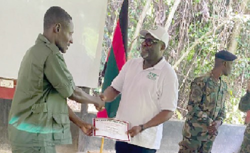 Isaac Noble Eshun, Ashanti Regional Manager, FSD, presenting a certificate to one of the recruits