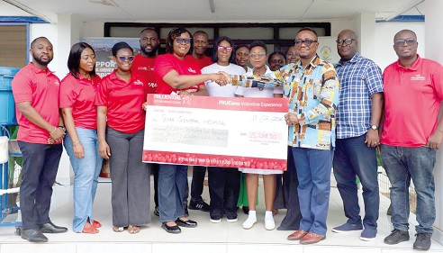 Dorothy Tsidi (4th from left), Chief Distribution Officer of Prudential Life, presenting a dummy cheque to representatives of Tema General Hospital