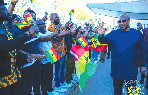 President John Dramani Mahama (right) responding to cheers from some Ghanaians who came to the Lyon Airport to welcome him