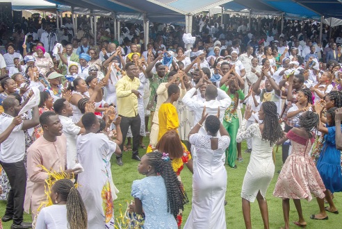 A section of a congregation dancing during praises