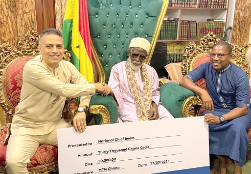 Ibrahim Misto (left), Chief Digital Officer of MTN Ghana, presenting a dummy cheque to Sheikh Usmanu Nuhu Sharubutu (middle), National Chief Imam. With them is Abdul-Mageed Rufai, Senior Commercial Manager of Mobile Money Limited