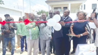 Executives of LiSAG cutting a tape to inaugurate the new building (inset)