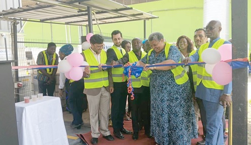 Gizella Tetteh-Agbotui (4th from right) being assisted by Jay Anjaria (left), Business and Country Head of Nutrifoods Ghana Limited, and other dignitaries to cut the ribbon to inaugurate the facility