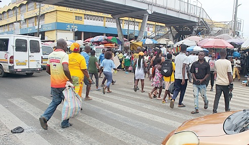 Some pedestrians using the Zebra crossing at the Kaneshie footbridge. Picture: ERNEST KODZI 