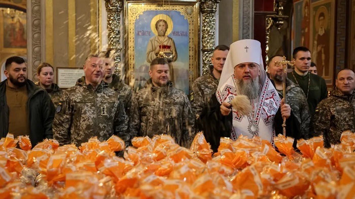 Metropolitan Epiphanius I, head of the Orthodox Church of Ukraine, sprinkled holy water to bless Easter cakes being transferred to Ukrainian servicemen on the front line this week
