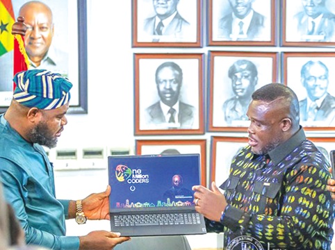 Samuel Nartey George (right),  Minister of Communication, Digital Technology and Innovations; and Mohammed Adams Sukparu, Deputy Minister of Communication, Digital Technology and Innovations, displaying one of the laptops