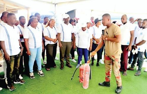 Emmanuel Quayson (right), Fireman, explaining the proper usage of the fire extinguisher to the congregation during the sensitisation programme