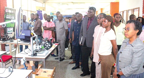 Mark A Taylor (4th from right), Council Chair, CSIR; Prof. Paul P Bosu (3rd from right), Director-General, CSIR, and some officials and participants observing some of the tools at the exhibition. Picture: ERNEST KODZI