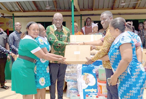 Nana Osei-Adjei (3rd from left), MP for New Juaben North, presenting the medical equipment to the management of the Akwadum Health Centre