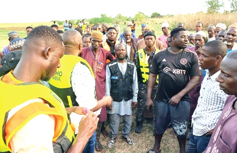 Rescue officials and residents gather near Mataiko after the canoe accident on the Volta Lake