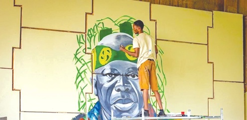 A student working on an artwork of the Asantehene, Otumfuo Osei Tutu II