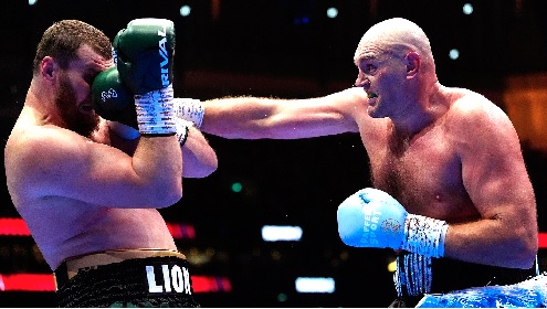 Tyson Fury (right) unleashes a straight right to the face of Arslanbek Makhmudov in last Saturday's bout