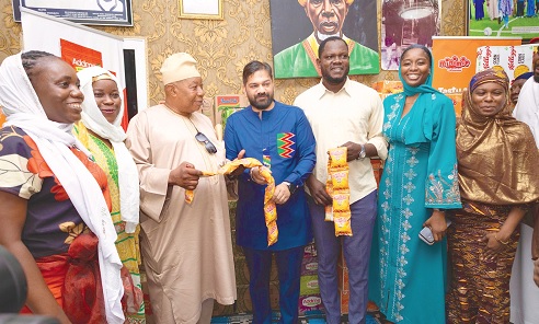 Rita Owusu Ansah (2nd from left), a social worker at Kumasi Children’s Home, and Daniel Mensah (3rd from left), CEO of Koinonia Group of Companies, with staff of the company and the children’s home