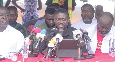 Paul. K. Mensah (middle), General Secretary of the Ghana Institute of Freight Forwarders and a member of the coalition, presenting the resolution of the association