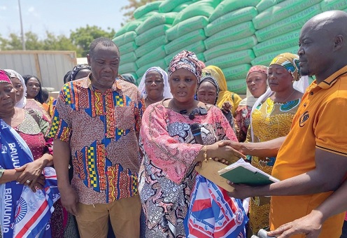 Hajia Safia Mohammed (2nd from right), Deputy National Women's Organiser of the NPP, presenting the items to Soyibu Yussif (right), Northern Regional Treasurer
